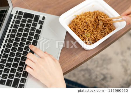 Woman eating cup yakisoba Woman eating cup yakisoba 115960950