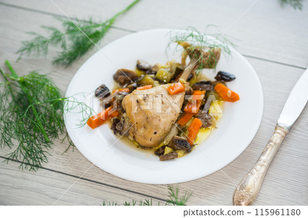 roast chicken with mushrooms and vegetables in a plate on a wooden table roast chicken with mushrooms and vegetables in a plate on a wooden table 115961180