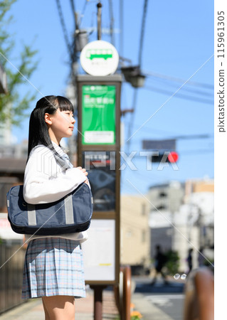 Girls waiting for a bus 115961305