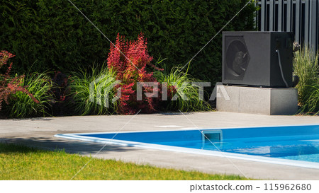 Heat pump unit beside a swimming pool with decorative greenery. 115962680