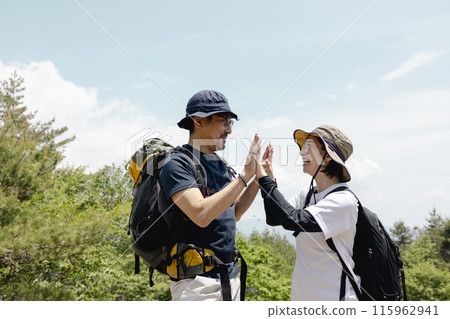 Parents and children enjoying hiking 115962941