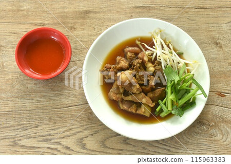 braised pork and fresh vegetable in herb brown soup on dish dipping spicy chili sauce  115963383