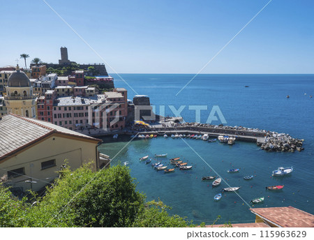 Picturesque view of Vernazza, with colorful houses, harbor, fishing boats, Vernazza Castle and clear blue sky. Typical traditional village in National park Cinque Terre, Vernazza,, Liguria, Italy Picturesque view of Vernazza, with colorful houses, harbor, fishing boats, Vernazza Castle and clear blue sky. Typical traditional village in National park Cinque Terre, Vernazza,, Liguria, Italy 115963629