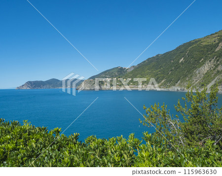 Coastline view from distance of the area Cinque Terre coast with Monterosso al Mare w and Corniglia Villages of National Park with ligurian sea and blue sky. La Spezia, Liguria, Beautiful mountain. 115963630