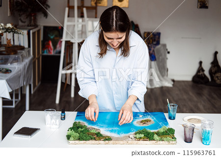 Artist Applying Final Touches to a 3D Epoxy Resin Coastal Artwork 115963761