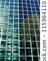 A high-rise building with glass windows that create beautiful reflections 115964110