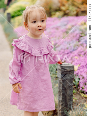 Portrait of cute child girl in blooming summer park. Portrait of cute child girl in blooming summer park. 115964445