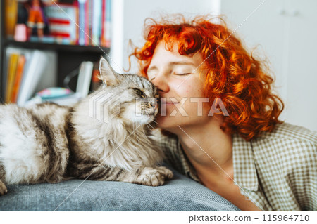 portrait red-haired attractive young woman with fluffy big cat 115964710