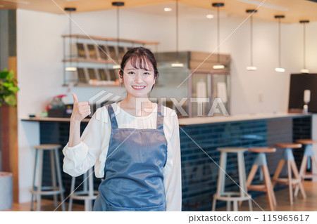 A smiling cafe staff woman A smiling cafe staff woman 115965617
