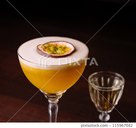 Elegant passion fruit cocktail with shot glass Elegant passion fruit cocktail with shot glass 115967082