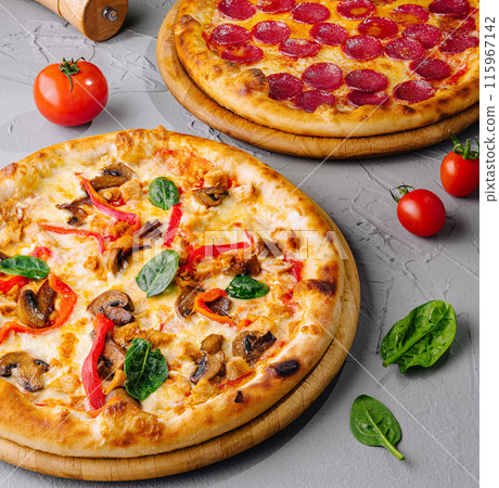 Delicious pepperoni and veggie pizzas on wooden boards 115967142