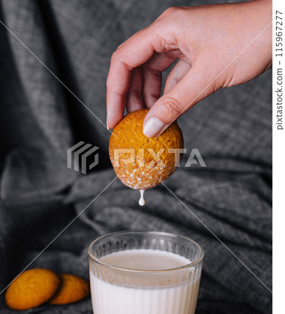 Dipping cookie in milk close-up 115967277