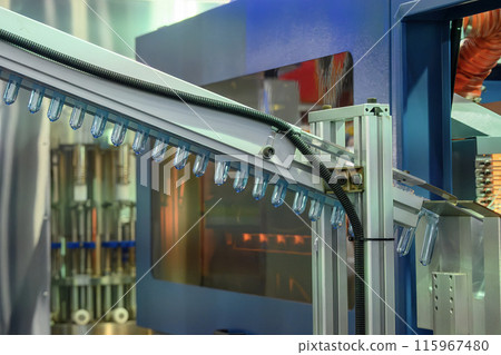 Conveyor belt deliver the preform shape to the  blow mold machine. 115967480