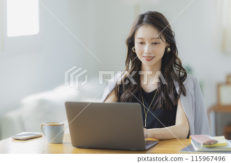 A young woman teleworking in the living room A young woman teleworking in the living room 115967496