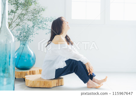 A woman relaxing in the room A woman relaxing in the room 115967647