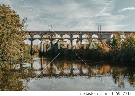 Railway Bridge with river in Bietigheim-Bissingen, Germany. Autumn. Railway viaduct over the Enz River, built in 1853 by Karl von Etzel on a sunny summer day. Bietigheim-Bissingen, Germany. Old Railway Bridge with river in Bietigheim-Bissingen, Germany. Autumn. Railway viaduct over the Enz River, built in 1853 by Karl von Etzel on a sunny summer day. Bietigheim-Bissingen, Germany. Old 115967712