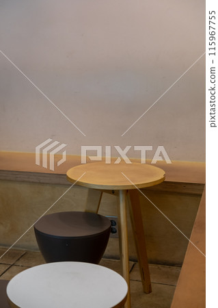Seating inside the cafe or restaurant, with wooden chairs and table 115967755