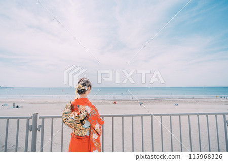 New adults walking along the beach in their best clothes 115968326