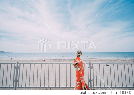 New adults walking along the beach in their best clothes New adults walking along the beach in their best clothes 115968328