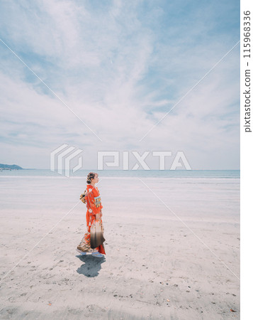 New adults walking along the beach in their best clothes 115968336