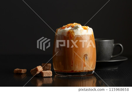 Iced coffee with whipped cream and caramel sauce and cup of black coffee. 115968658
