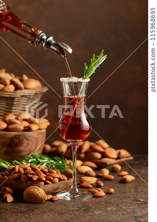 Italian liqueur Amaretto with almonds nuts on a wintage table. 115968695