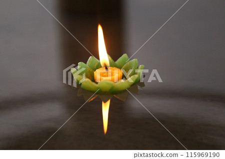 Candles of Krathong with flames floating on the water. Candles of Krathong with flames floating on the water. 115969190