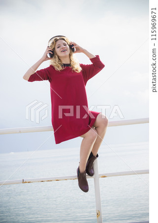 Happy woman wearing headphones outdoor Happy woman wearing headphones outdoor 115969671