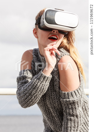 Woman wearing VR outside 115969672