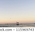 fisherman boat at sunset 115969743