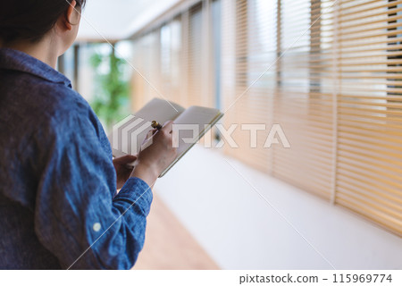 A woman with a memo pad A woman with a memo pad 115969774