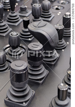 Various control sticks on a black dashboard Various control sticks on a black dashboard 115969788