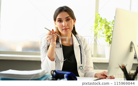Beautiful smiling female doctor at workplace portrait Beautiful smiling female doctor at workplace portrait 115969844