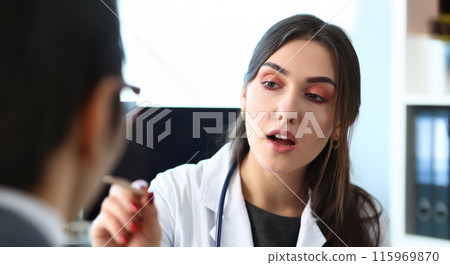 Beautiful smiling female doctor talk with patient 115969870