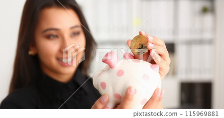 A young smiling chinese woman holding 115969881