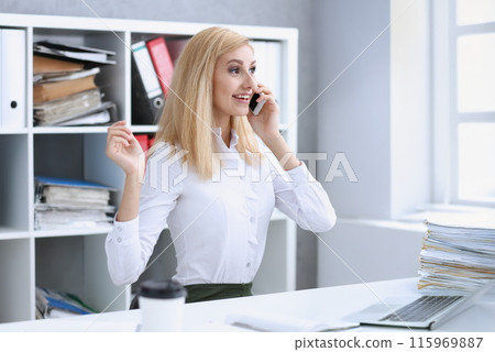 Beautiful blonde smiling businesswoman talk cellphone 115969887