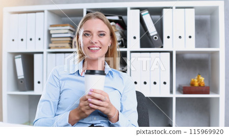 Smiling business woman drinking coffee Smiling business woman drinking coffee 115969920