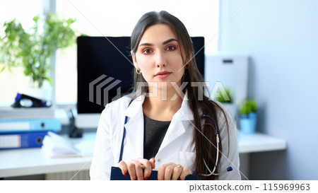 Beautiful smiling female doctor at workplace portrait 115969963