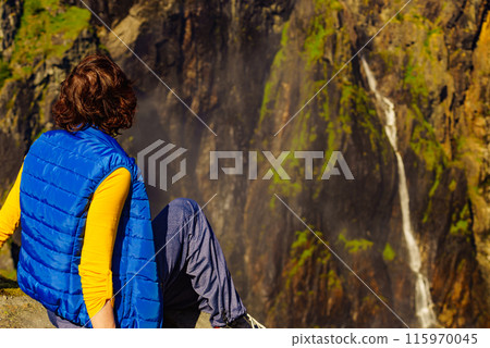Tourist woman at Voringsfossen waterfall Norway Tourist woman at Voringsfossen waterfall Norway 115970045
