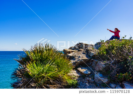 Tourist woman on sea cliffs in Spain Tourist woman on sea cliffs in Spain 115970128