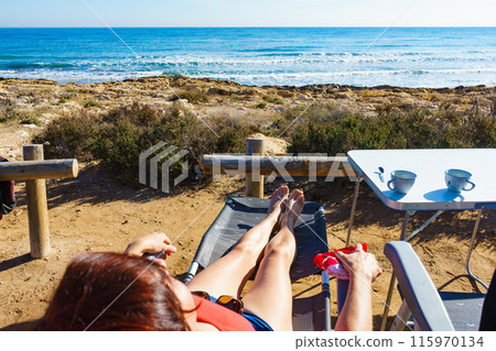 Tourist woman on beach enjoying vacation 115970134