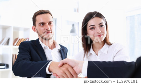 Smiling man in suit shake hands as hello Smiling man in suit shake hands as hello 115970191
