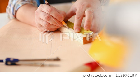 Arms of worker measuring wooden bar Arms of worker measuring wooden bar 115970197