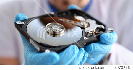 A male repairman wearing blue gloves 115970238