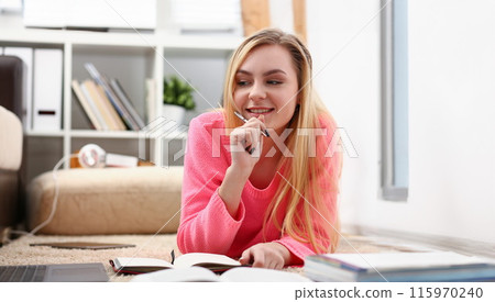 young beautiful blond woman lie on the floor read book young beautiful blond woman lie on the floor read book 115970240