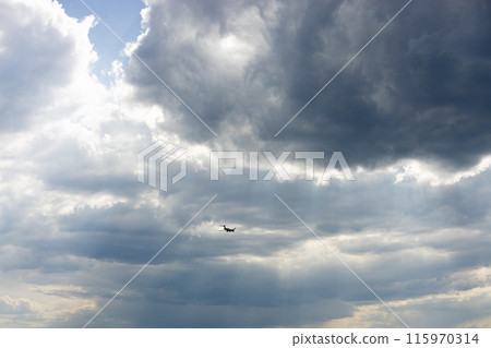 Passenger airplane flying in the sky amazing clouds in the background. Travel by air transport. 115970314