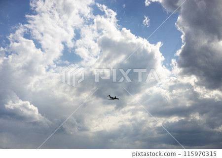 Passenger airplane flying in the sky amazing clouds in the background. Travel by air transport. Passenger airplane flying in the sky amazing clouds in the background. Travel by air transport. 115970315