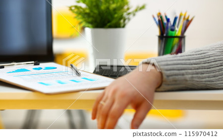 Silver pen lying on important stats paper clipped to pad Silver pen lying on important stats paper clipped to pad 115970412
