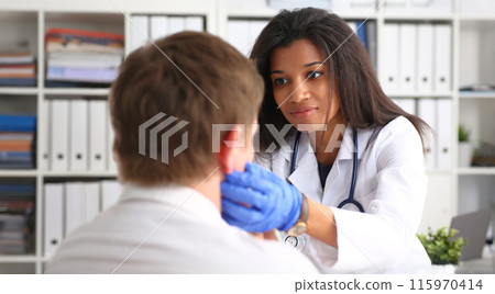 Beautiful black smiling female doctor talk with 115970414