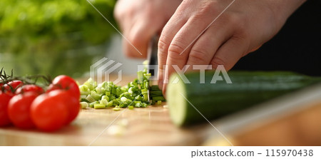Cook holds knife in hand and cuts on Cook holds knife in hand and cuts on 115970438